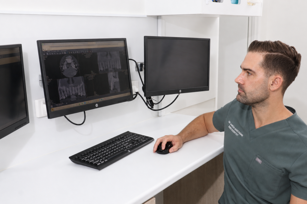 Endodontist with X-ray to treat a dental injury in North Brisbane.