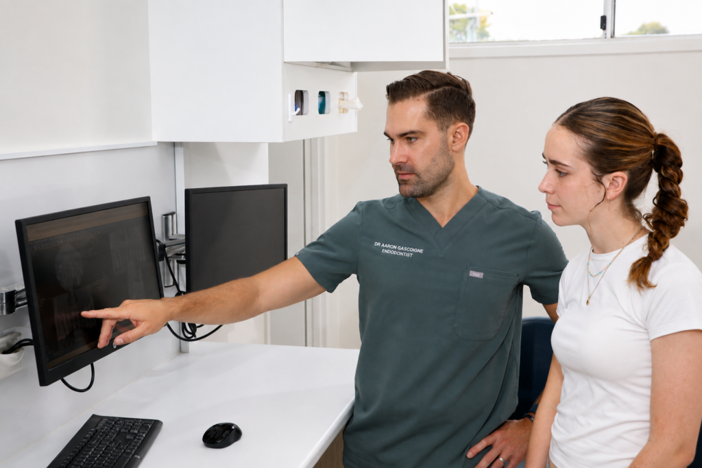 Endodontist discussing treatment with a patient in North Brisbane